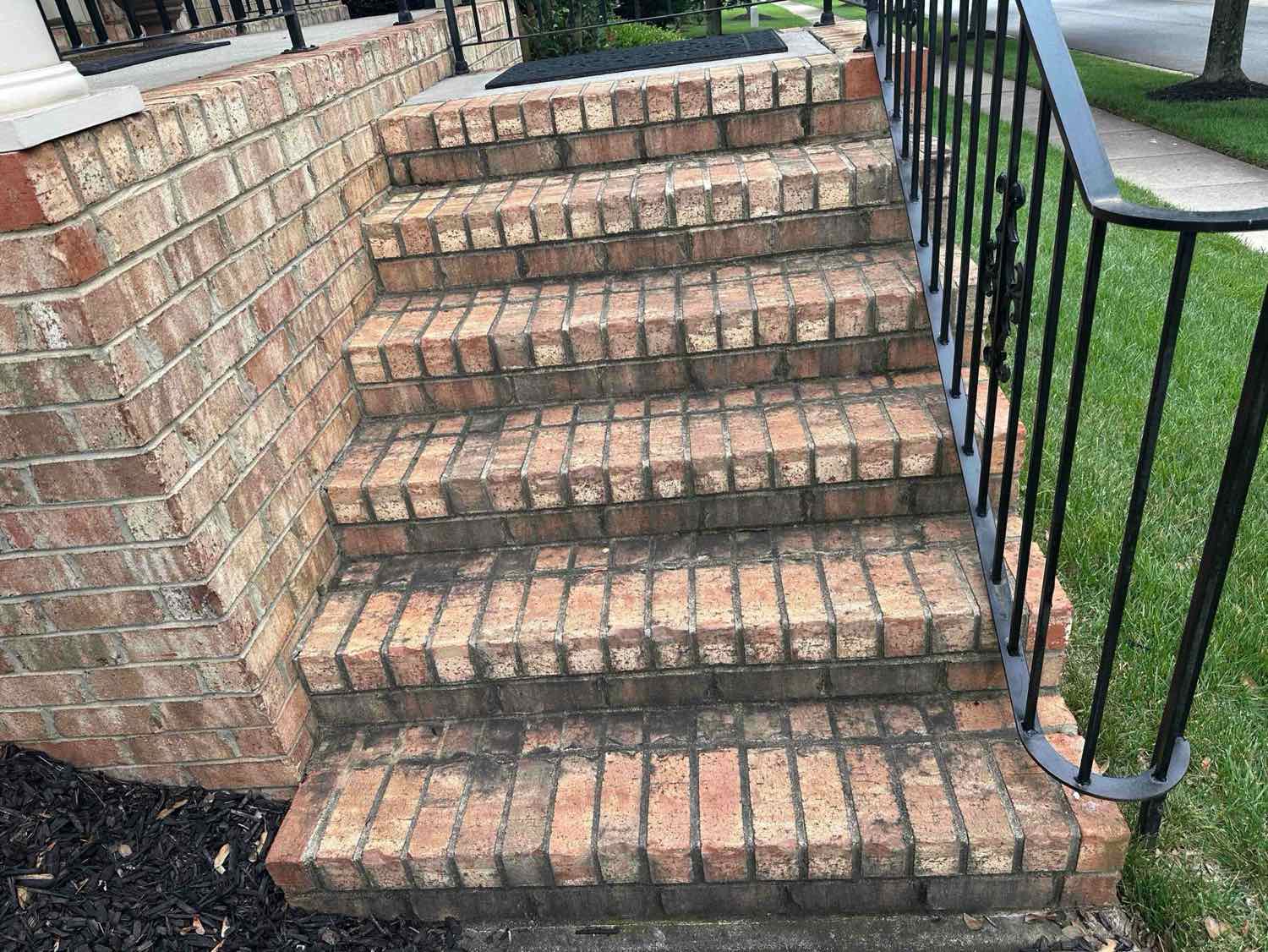 Clean red-brick front steps at a Charlotte home on a bright day.