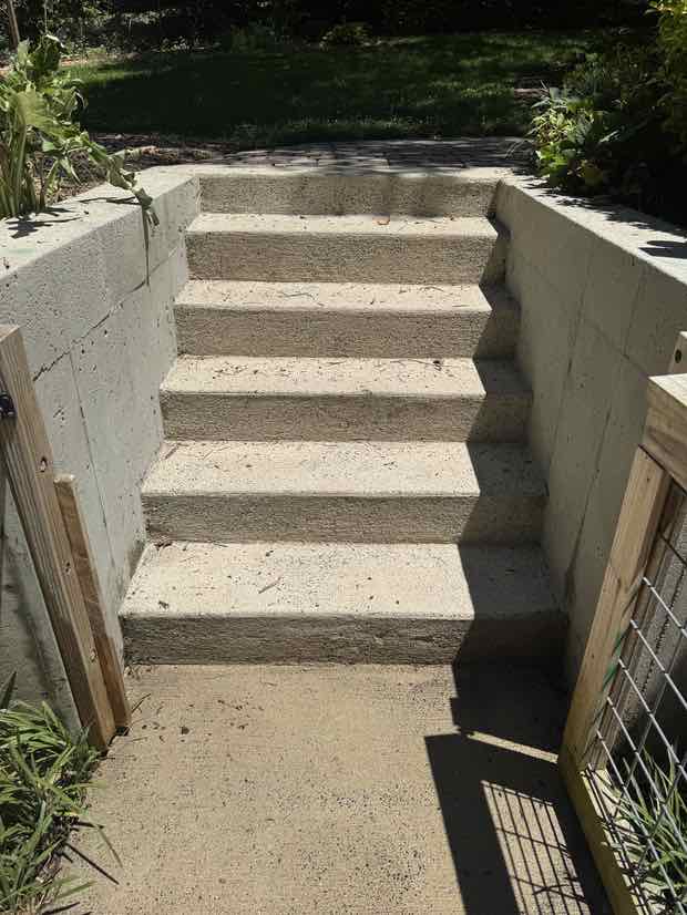 The same concrete steps after washing — pale, clean and evenly bright.
