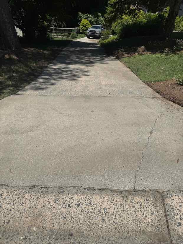 A clean, evenly bright concrete driveway after pressure washing.